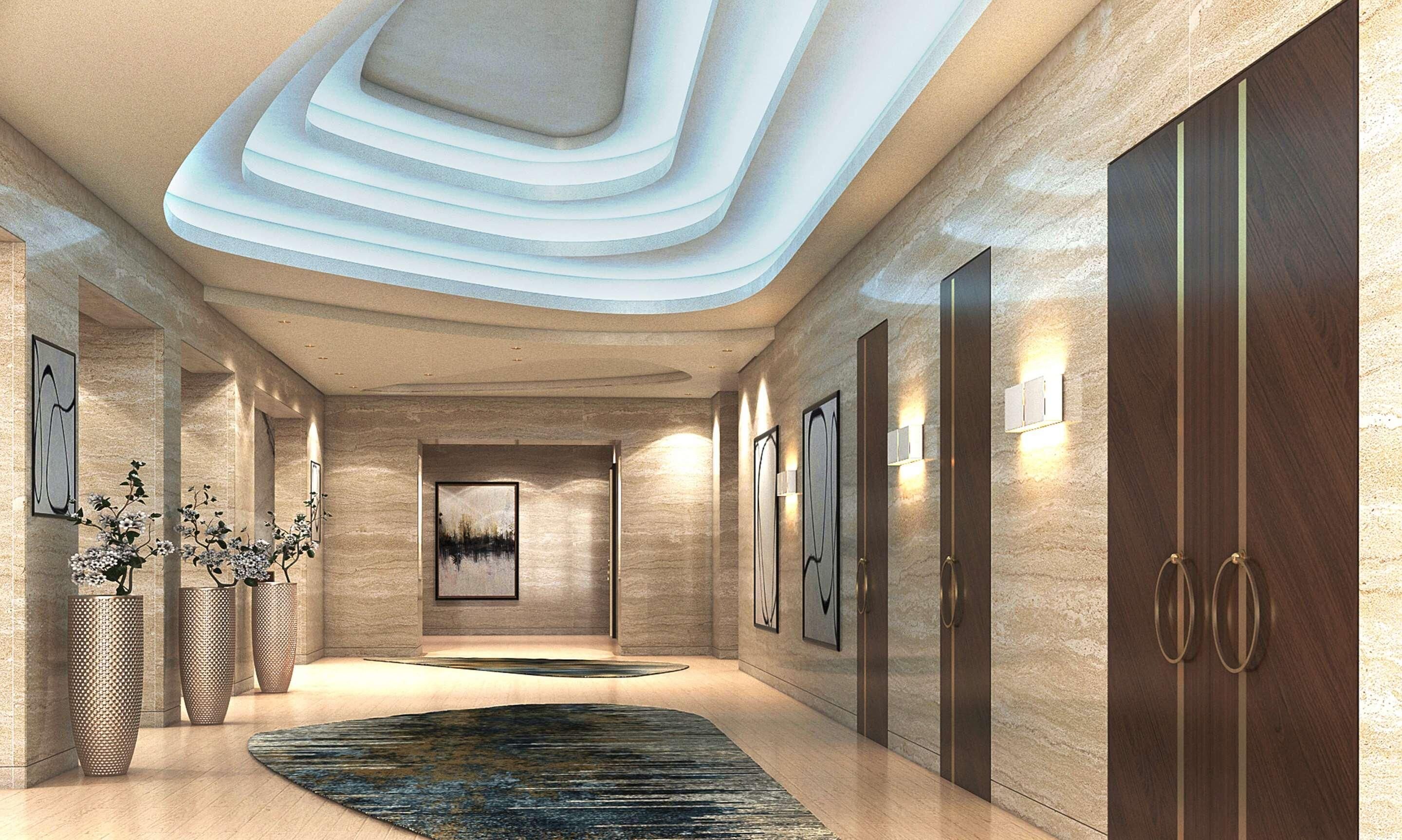 A modern hallway with a geometric ceiling design, framed artwork, and a patterned rug.