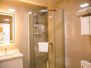 A modern bathroom with a glass-enclosed shower, a sink, and a towel rack. - Greentree Inn Nanjing Zhongshan Mausoleum Scenic Area Zhongling Street Subway Station Express Hotel (Nanjing)