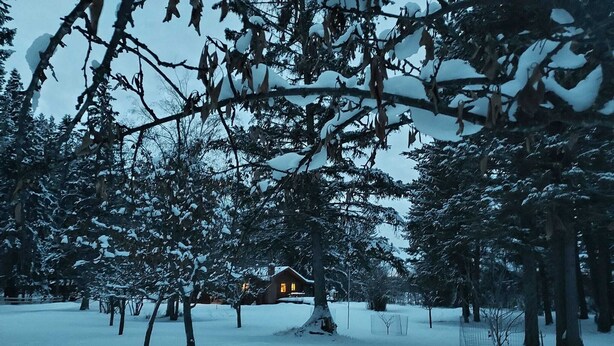 A snow-covered landscape with a house in the background. - Swan Mntn View--Entire, Private Basement Suite, Close to GNP, Whitefish & Lake. (Kalispell)