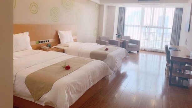 A hotel room with two beds, a desk, and a chair. - Greentree Inn Zhenjiang Dagang New District Tonggang Road Butterfly Square (Zhenjiang)