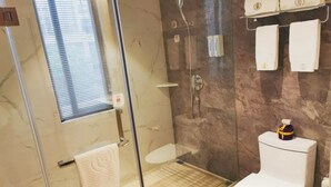 A bathroom with a glass-enclosed shower, a toilet, and a towel rack with two towels. - GYA Jiangsu Provinceyancheng City Oubao Liya Life Plaza Hotel (Yancheng)