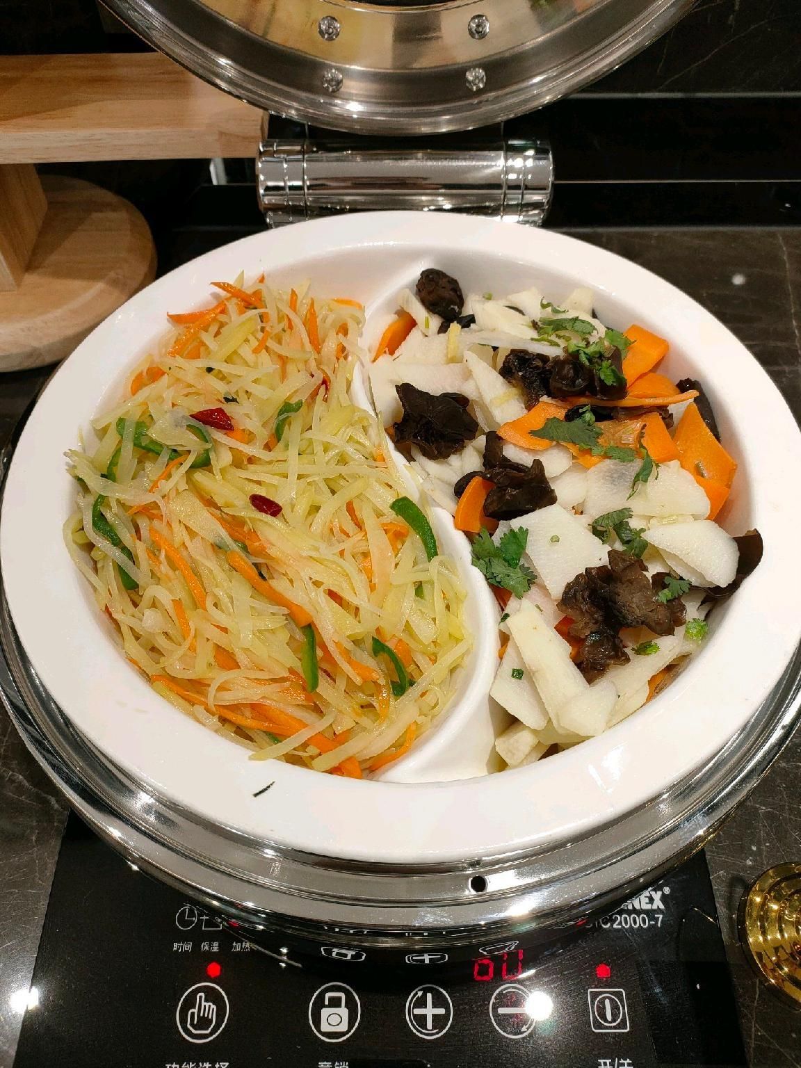 A kitchen with a stove and two bowls of food.