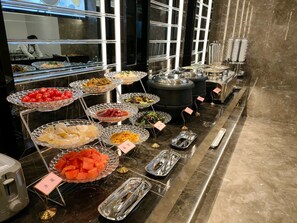 A buffet setup with various food items displayed in glass bowls and trays. - GYA Jiangsu Provinceyancheng City Oubao Liya Life Plaza Hotel (Yancheng)