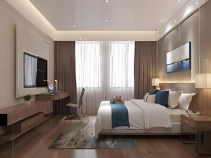 A modern bedroom with a large bed, a desk, a TV, and a flat-screen TV mounted on the wall.