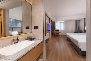 A hotel room with a large bathroom sink, a bed, a desk with a chair, and a television. - Starway Hotel (Taixing Wuyue Plaza Jichuan North Road) (Taixing)