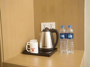 A coffee maker, two water bottles, and a mug on a tray. - Shell Changzhou Cashmere City Hotel (Changzhou)