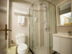 A modern bathroom with a glass-enclosed shower, a toilet, and a sink. - Shell Changzhou Cashmere City Hotel (Changzhou)