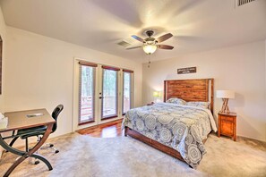 A bedroom with a bed, a desk, a chair, a ceiling fan, and a nightstand. - Wooded Yard, Gas Grill: Lush Pinetop Retreat (Pinetop)