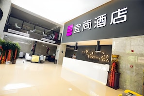 A hotel lobby with a reception desk, a staircase, and a modern interior design. - Echarm Hotel Hefei Binhu Exhibition Center (Hefei)