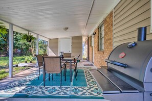 Enjoy al fresco dining on the patio, where a barbecue grill and table with four chairs await.