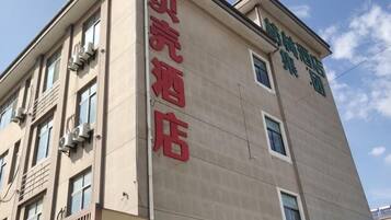 A building with a sign that reads 'Hotel' in large letters.