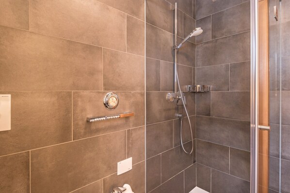 A shower with a handheld showerhead, a wall-mounted faucet, and a control panel. - Apartment "La Grambla Sella 1" with Mountain View, Balcony & Wi-Fi (St.Christina)