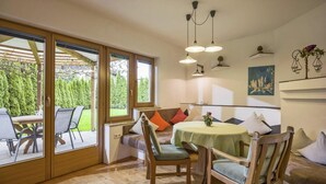 A cozy dining area with a round table, chairs, and a bench.