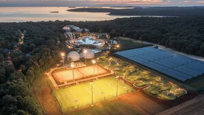 An aerial view of a resort with a swimming pool, tennis courts, and solar panels. - Luxury Beach Villas Porto Bus (Bale)
