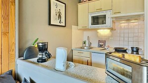 A compact kitchen with a microwave, toaster, and coffee maker.