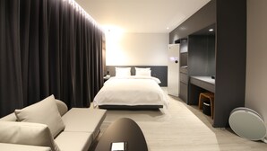 A modern hotel room with a large bed, a sofa, a desk, and a mirror. - Hotel Stay Gumi (Gumi)