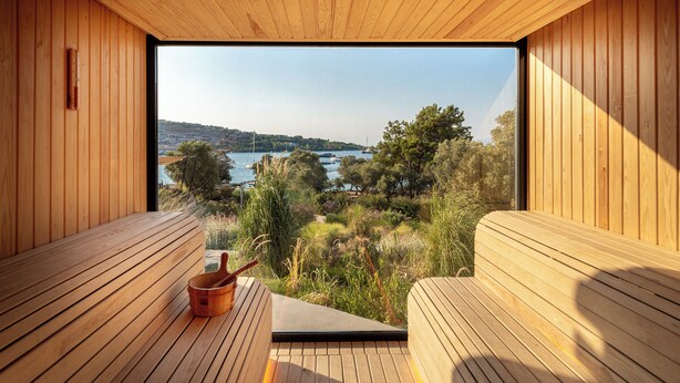 A wooden sauna with a bench and a bucket, overlooking a lake and trees. - Bobo by The Stay (Bodrum)