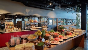 A buffet setup with various food items and condiments. - Scandic Örebro Central (Örebro)