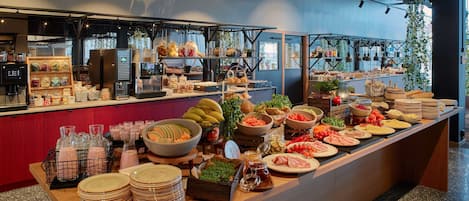 A buffet setup with various food items and condiments.