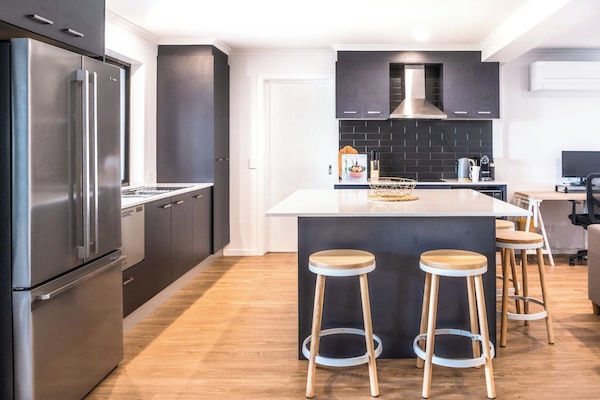 Modern open plan kitchen with island seating.