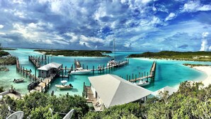 A coastal resort with multiple docked boats, a pier, and a beach. - Bahamas Luxury Sailing Catamaran, Nassau to Exumas (Staniel Cay)