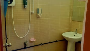 A bathroom with a shower, sink, and toilet.