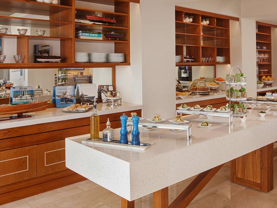 A buffet setup with various food items and condiments.