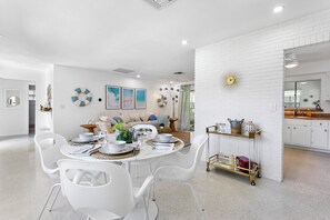 Enjoy meals in this stylish dining area with a round table and comfortable seating.