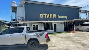 A building with a sign reading "D'TAMPI homestay" and a white pickup truck parked in front. - OYO Home 90370 D'tampi Homestay (Semporna)