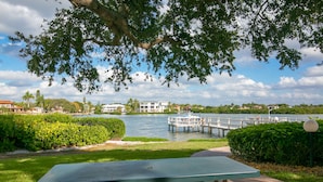 A riverside park with a dock, a table, and a bridge. - Siesta Key Condo- walk to beautiful beaches, ride a free trolley around the key  (Sarasota)
