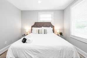 Relax in comfort with a large bed, bedside tables, and a soothing ambiance.