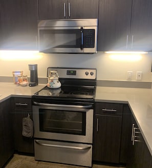 Fridge, microwave, coffee/tea maker, cookware/dishes/utensils