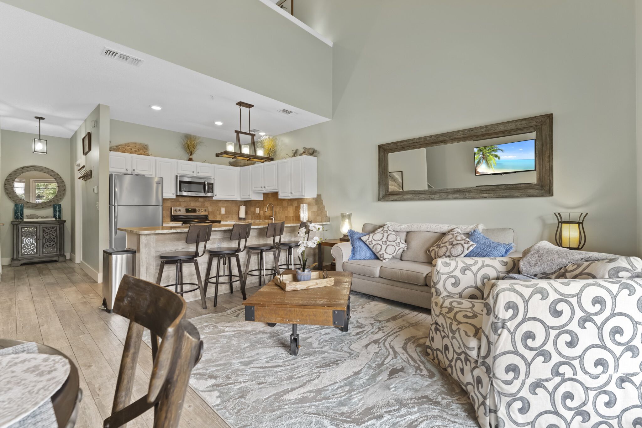 A modern living room with a sofa, coffee table, and dining area.