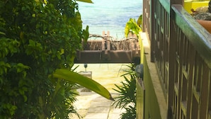 A staircase leading to a beach with a view of the ocean. - Penthouse villa on the beach, chef services available- extra cost.  (Ocho Rios)