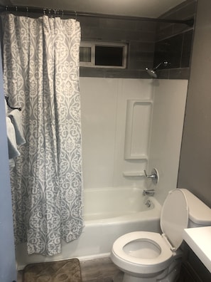 Combined shower/bathtub, hair dryer, towels, soap