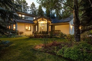 A two-story house with a front porch, garage, and a well-maintained garden. - Abode at Fish Creek, mountain escape, hot tub (Wilson)