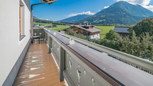A balcony with a view of a mountain and a road.