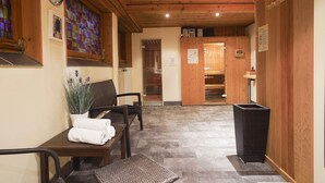 A wooden interior with a reception desk, chairs, a potted plant, and a tiled floor. - Vacation apartment Untersberg 2 persons, 52 sqm (Schönau am Königssee)