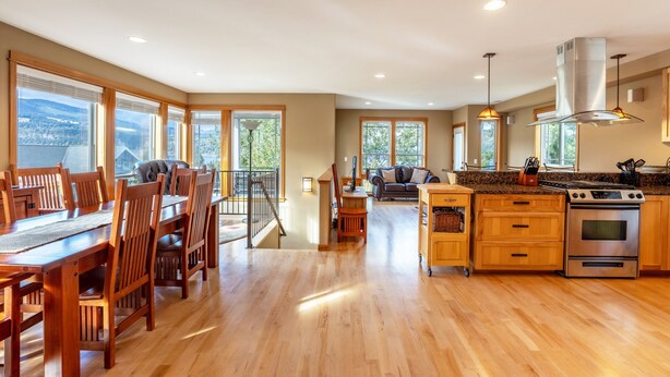 A spacious kitchen with wooden cabinets, a large island, and a built-in oven.