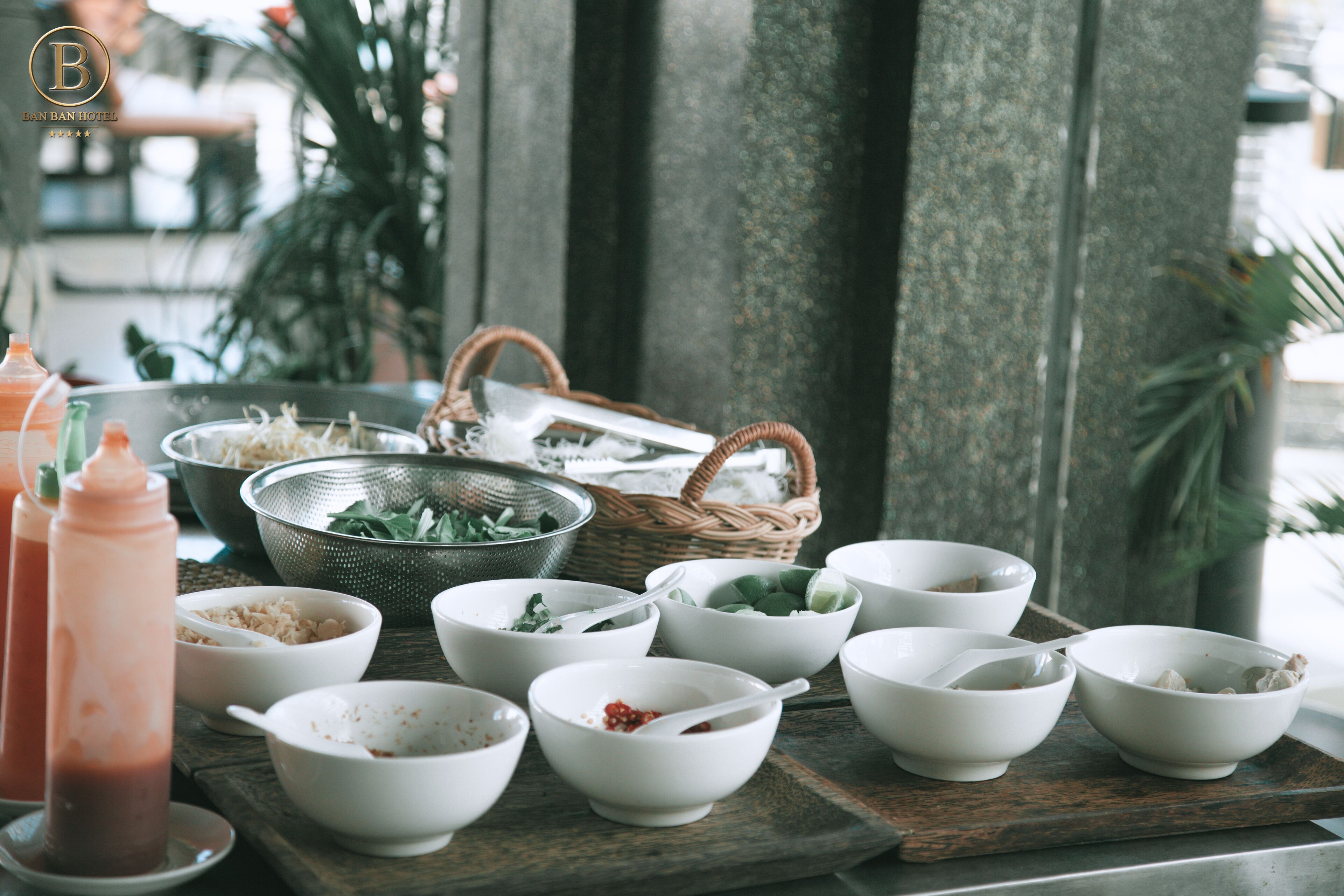 A table with various bowls and a colander, likely for a meal setting.