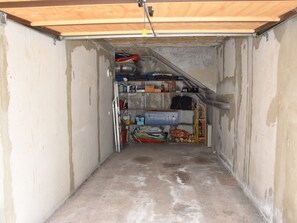 Functional storage area with shelving and racks for tools and supplies.