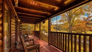 A wooden deck with a railing, a bench, and a table. - Southern Serenity, Hot tub, Pool Table,  Wifi, $560 FREE tickets each paid day! (Sevierville)