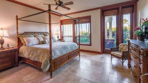 A four-poster bed with a canopy, a wooden nightstand, a chair, and a dresser.