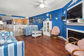 Cozy living space with a fireplace, television, and comfortable seating.