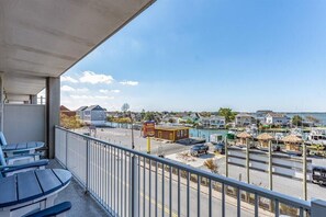 Enjoy breathtaking views of the marina and coastal town from this balcony.