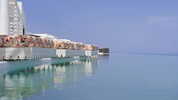 Seasonal outdoor pool, open 11:00 AM to 7:30 PM, pool umbrellas