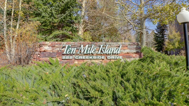 A sign for Ten Mile Island at 222 Creekside Drive, surrounded by greenery and trees. - 2 Bedroom Condo Just off Frisco Main Street. B207 (Frisco)