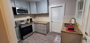 Enjoy cooking in this kitchen with a microwave, stainless steel oven, and coffee maker.