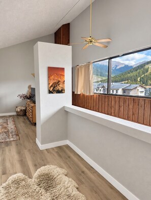 A room with a wooden ceiling, a ceiling fan, a window with curtains, a painting, a wooden dresser, and a rug. - Short Walk to Slopes, Great Views, Shared Hot Tub (Frisco)