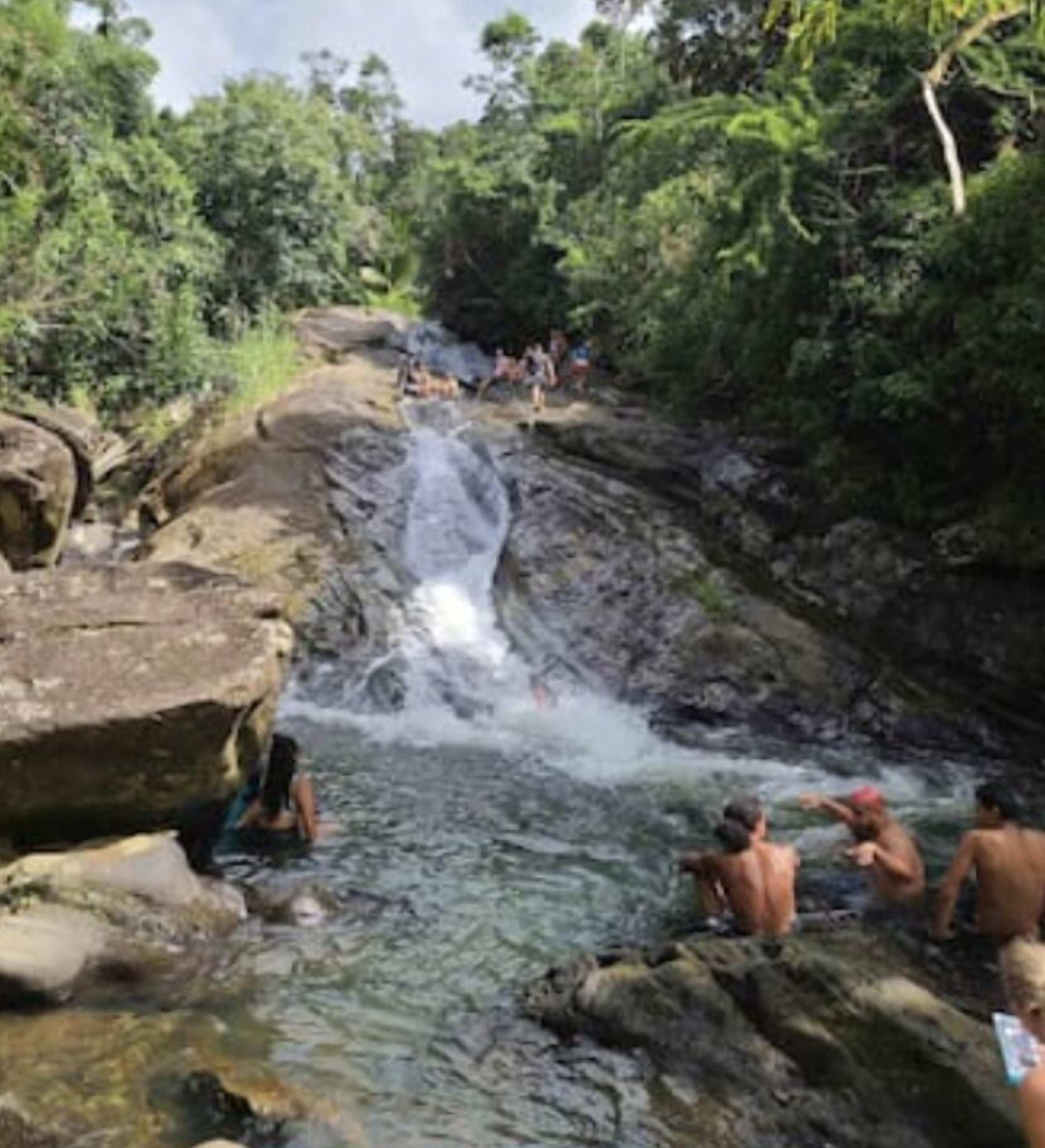 A natural water feature with people enjoying the area.